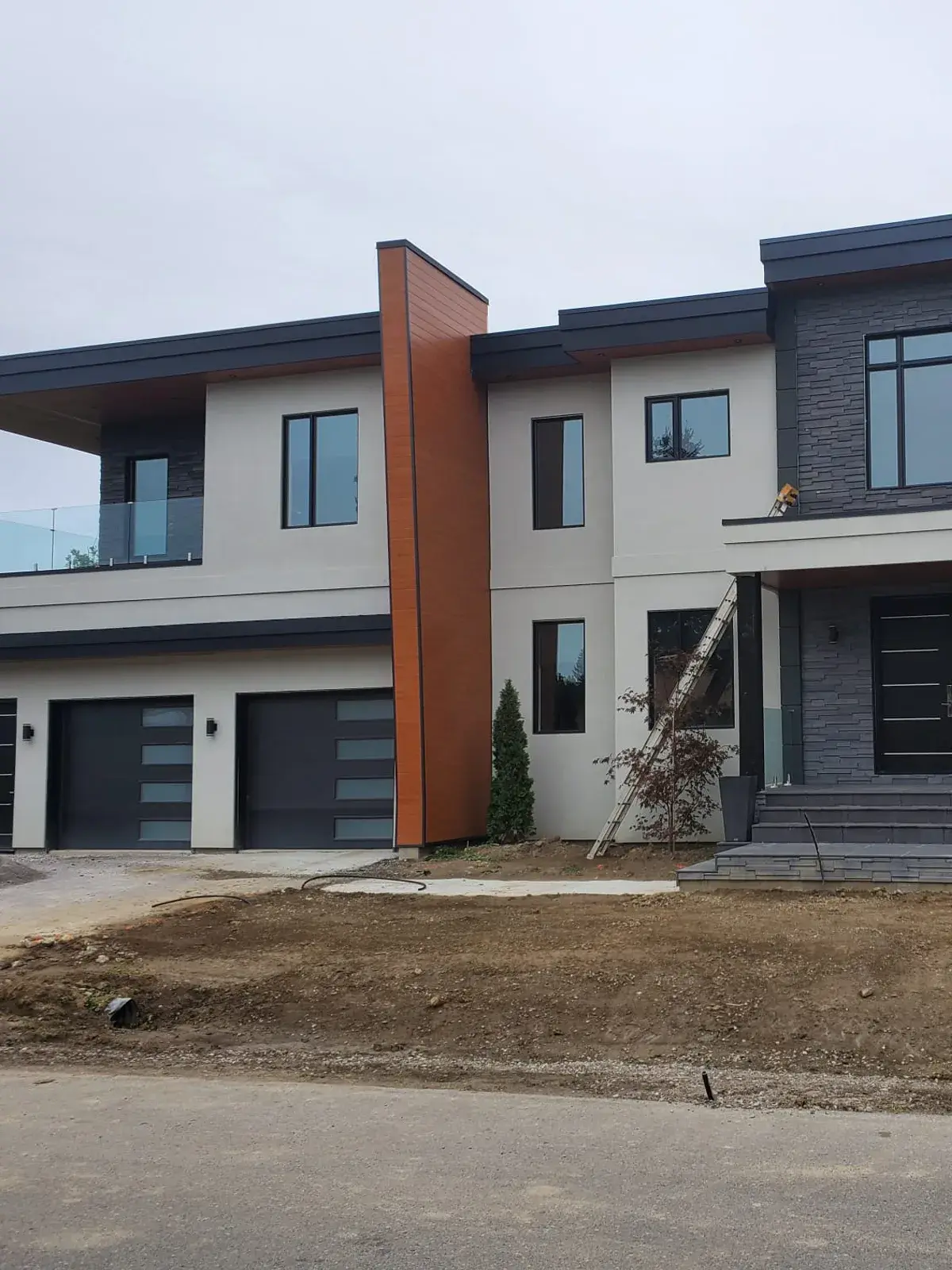 Contemporary residence with flat stucco panels and dark accents