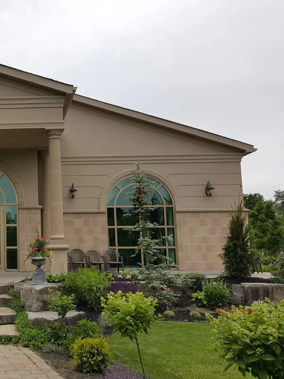 Classical stucco portico with columns and architectural moulding